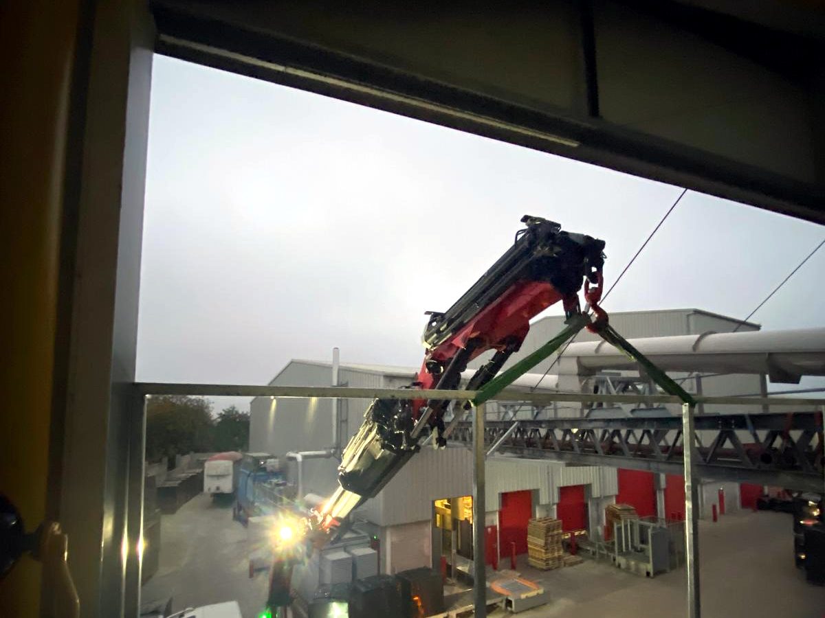 Night-time close-up of an AC Lifting HIAB cab and driver at work.