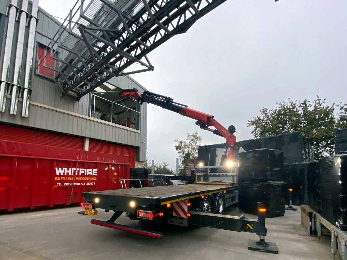 HIAB crane boom raised high against a dramatic sky.