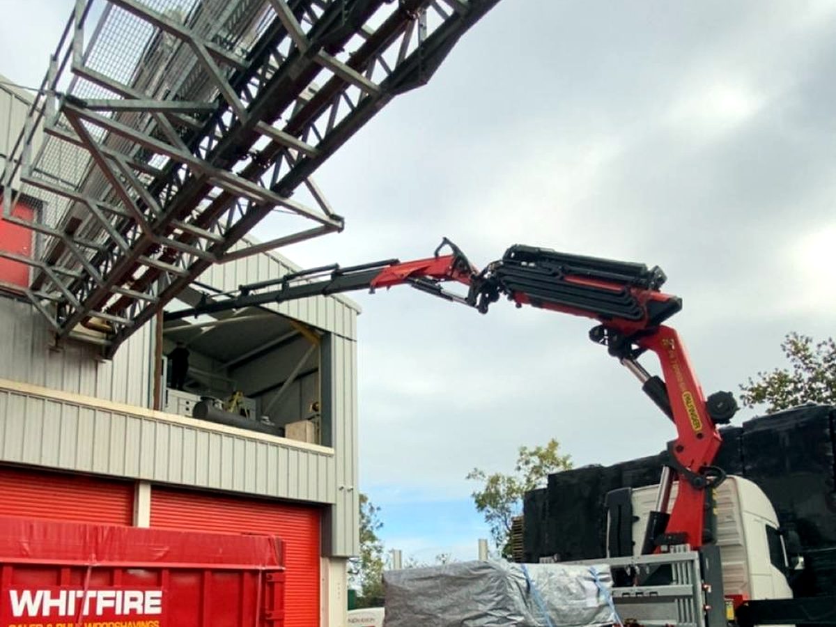 Close-up of an AC Lifting HIAB boom at an industrial customer site.