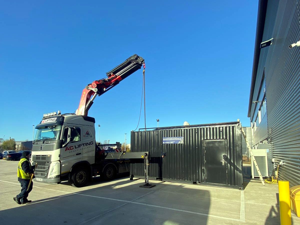 HIAB crane extended at an industrial customer site.