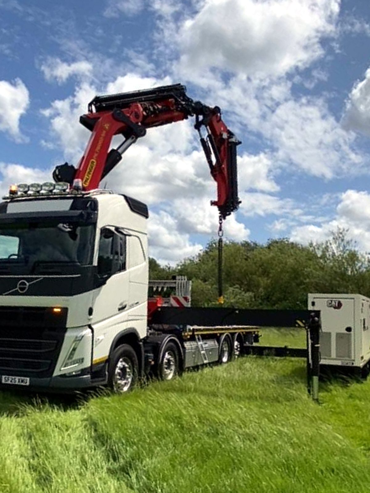 HIAB-mounted crane lorry parked in open countryside in North West England.