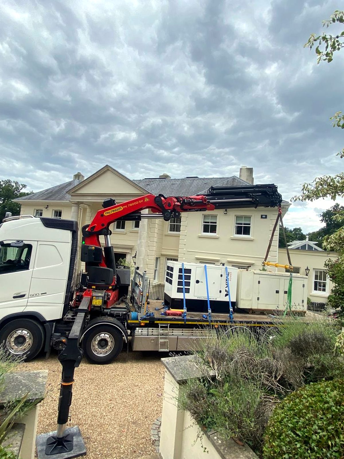 AC Lifting HIAB on a residential road — suitable access for over-house craning and hot tub lifts.