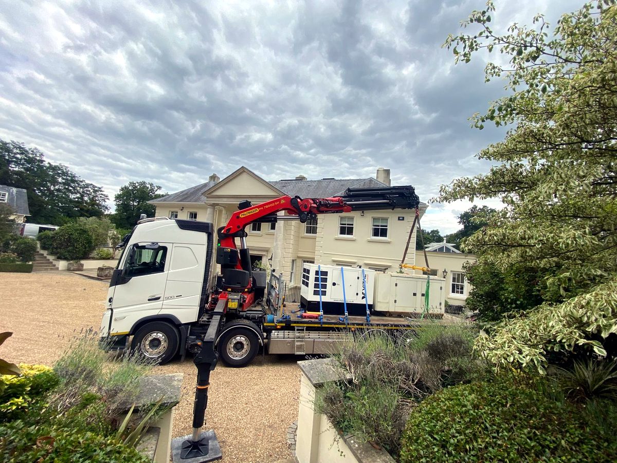 AC Lifting HIAB on a residential road — suitable access for over-house craning and hot tub lifts.