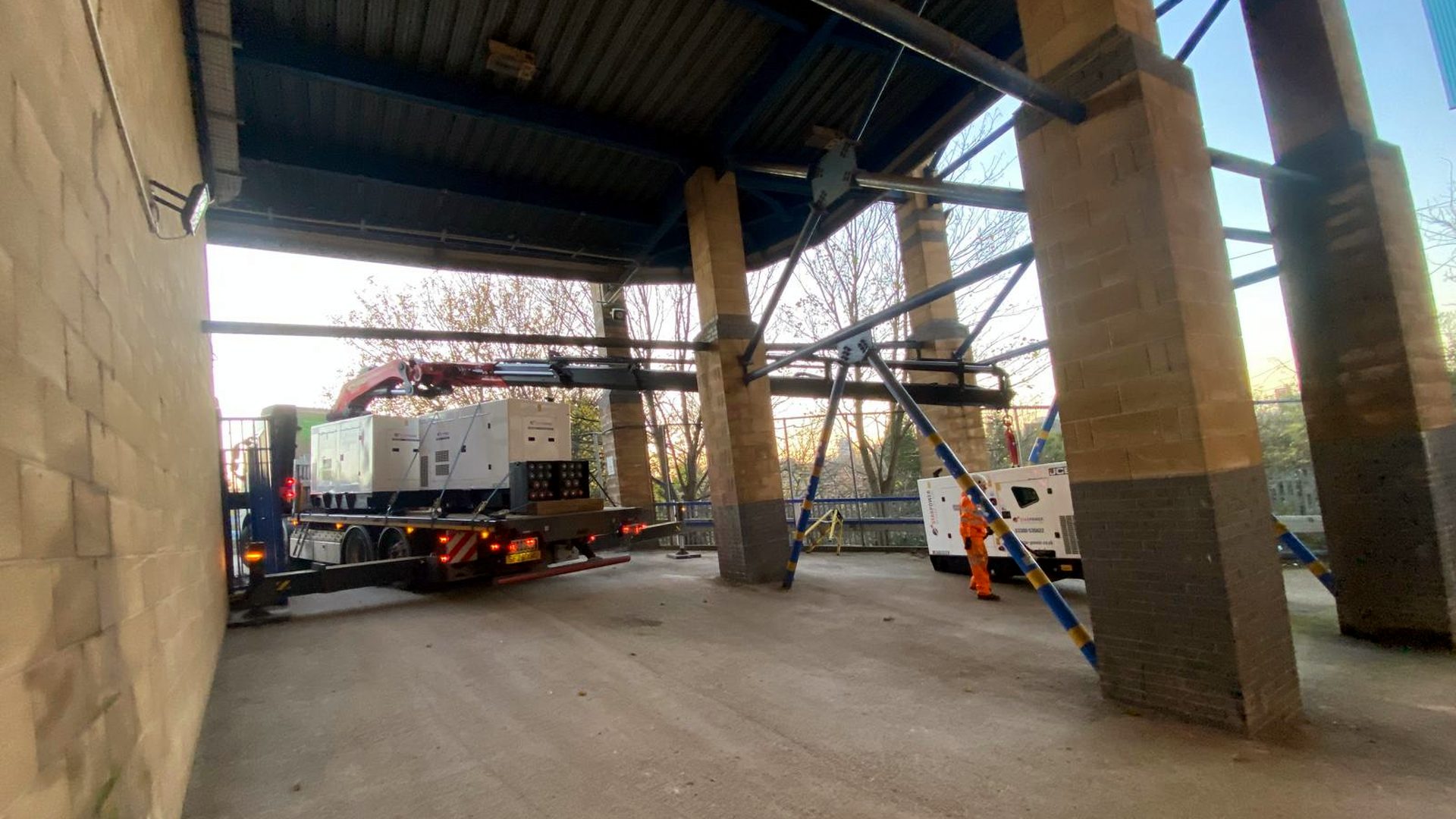 AC Lifting HIAB rig parked inside a tall industrial facility.