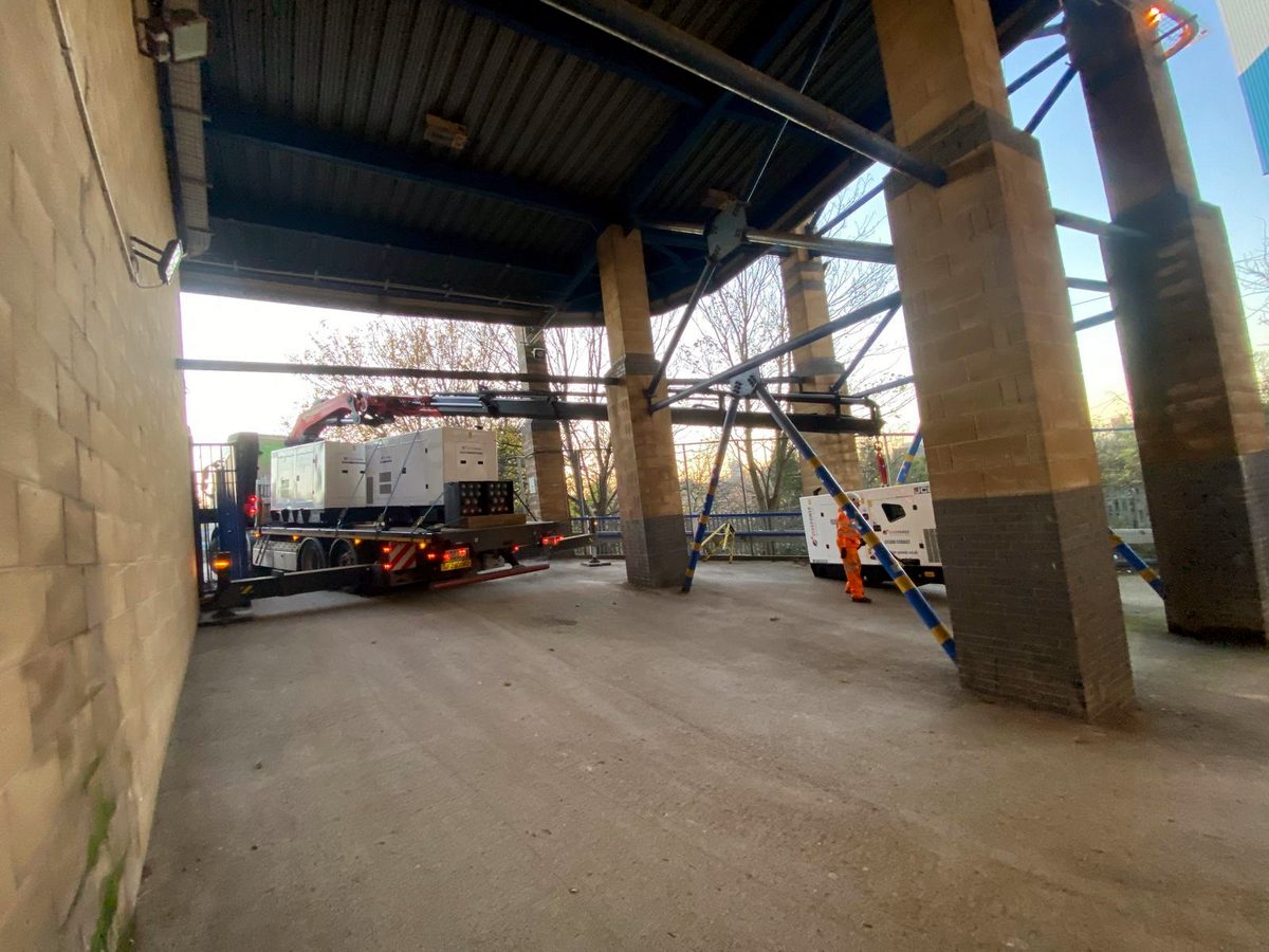 AC Lifting HIAB rig parked inside a tall industrial facility.