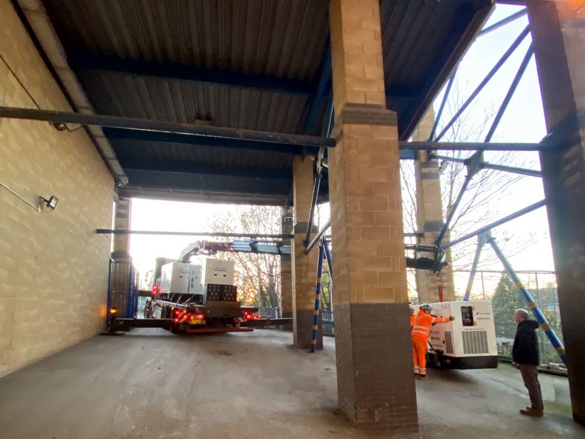 AC Lifting HIAB navigating a tight structural clearance on a delivery.