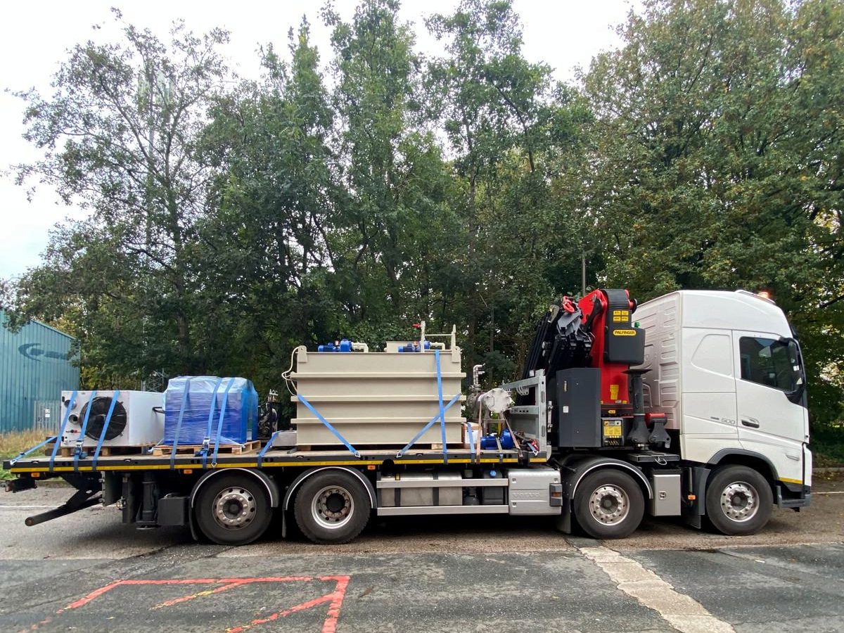 AC Lifting HIAB with palletised materials at a yard delivery.