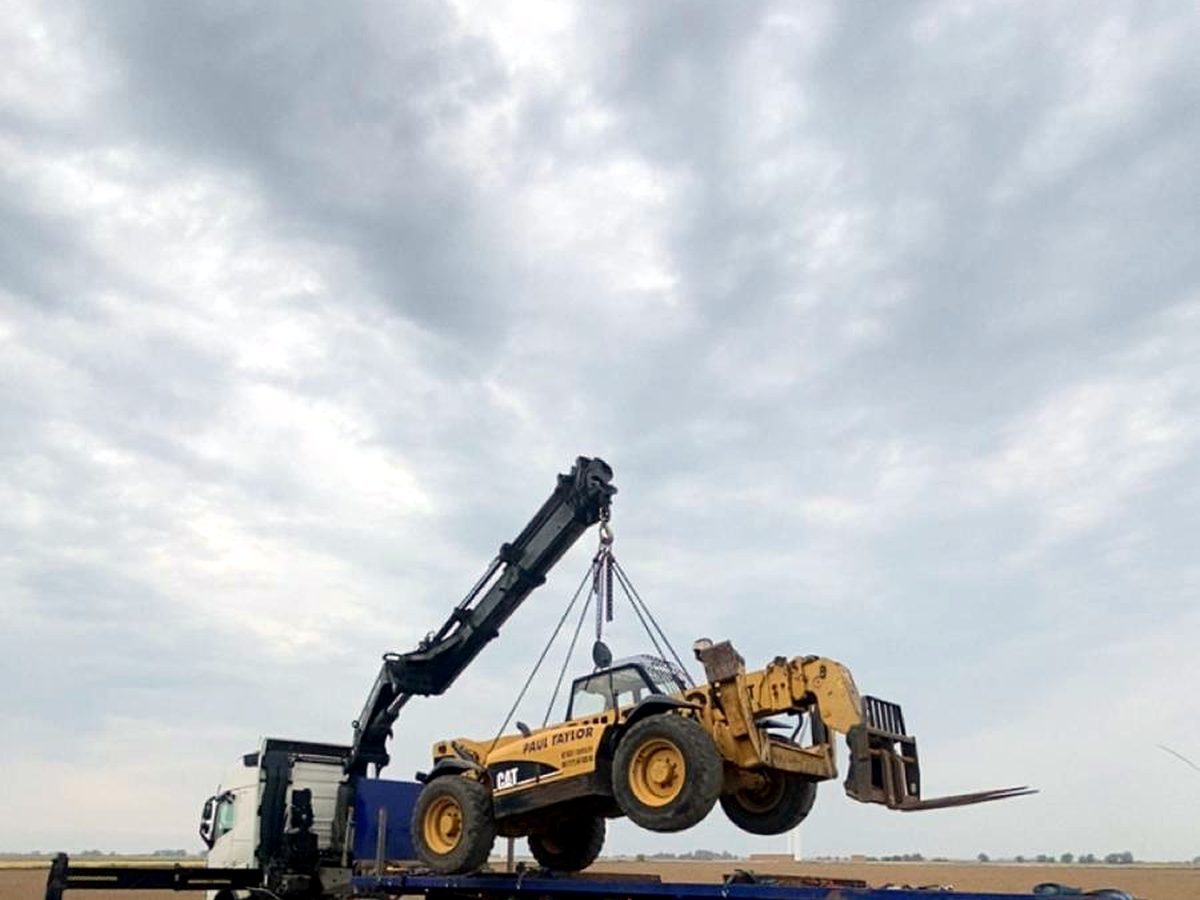 Construction plant loaded onto an AC Lifting HIAB ready for a plant-hire delivery.