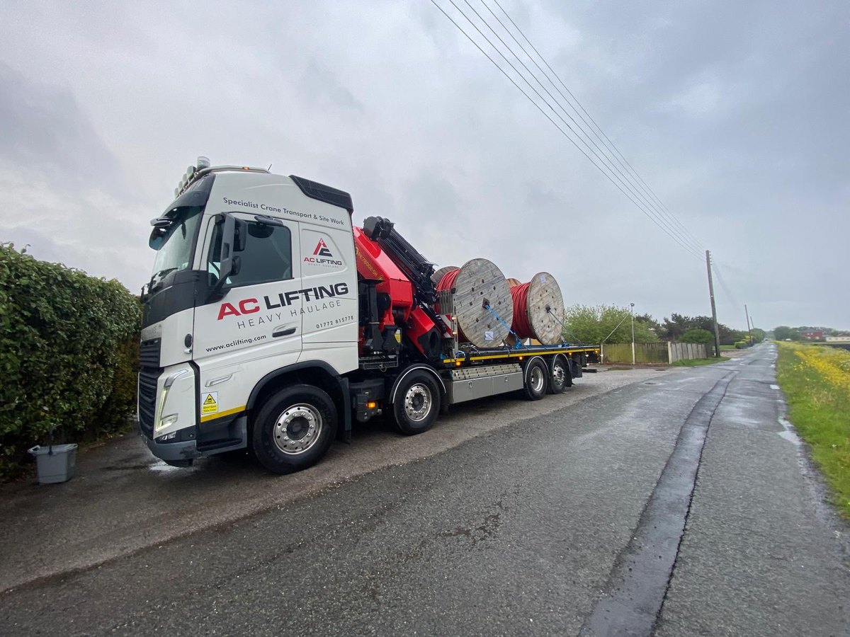 AC Lifting HIAB lorry loaded with electricity cable drums on a rural delivery run.