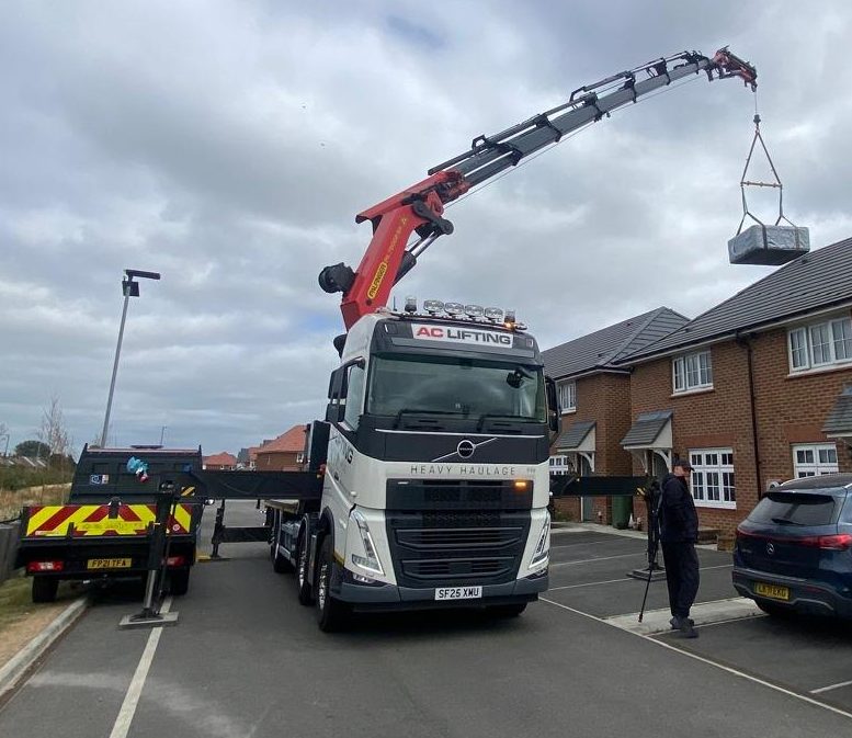 AC Lifting HIAB crane lifting over new-build housing.