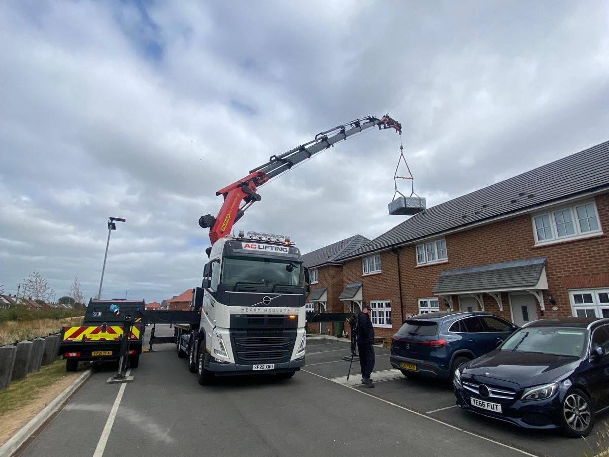 AC Lifting HIAB crane lifting over new-build housing.