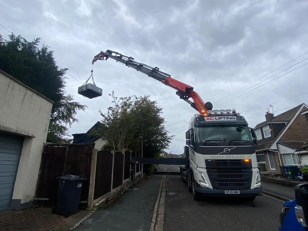 AC Lifting HIAB lifting over a tight residential driveway.