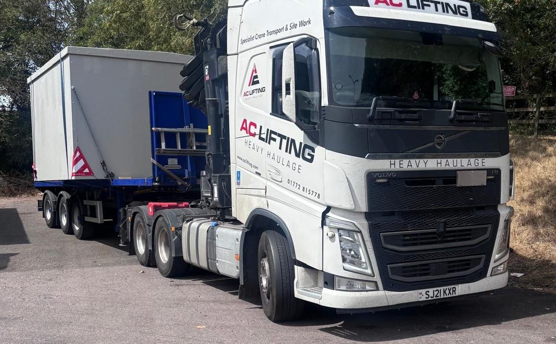 AC Lifting low-loader transporting a large fabricated hopper section.