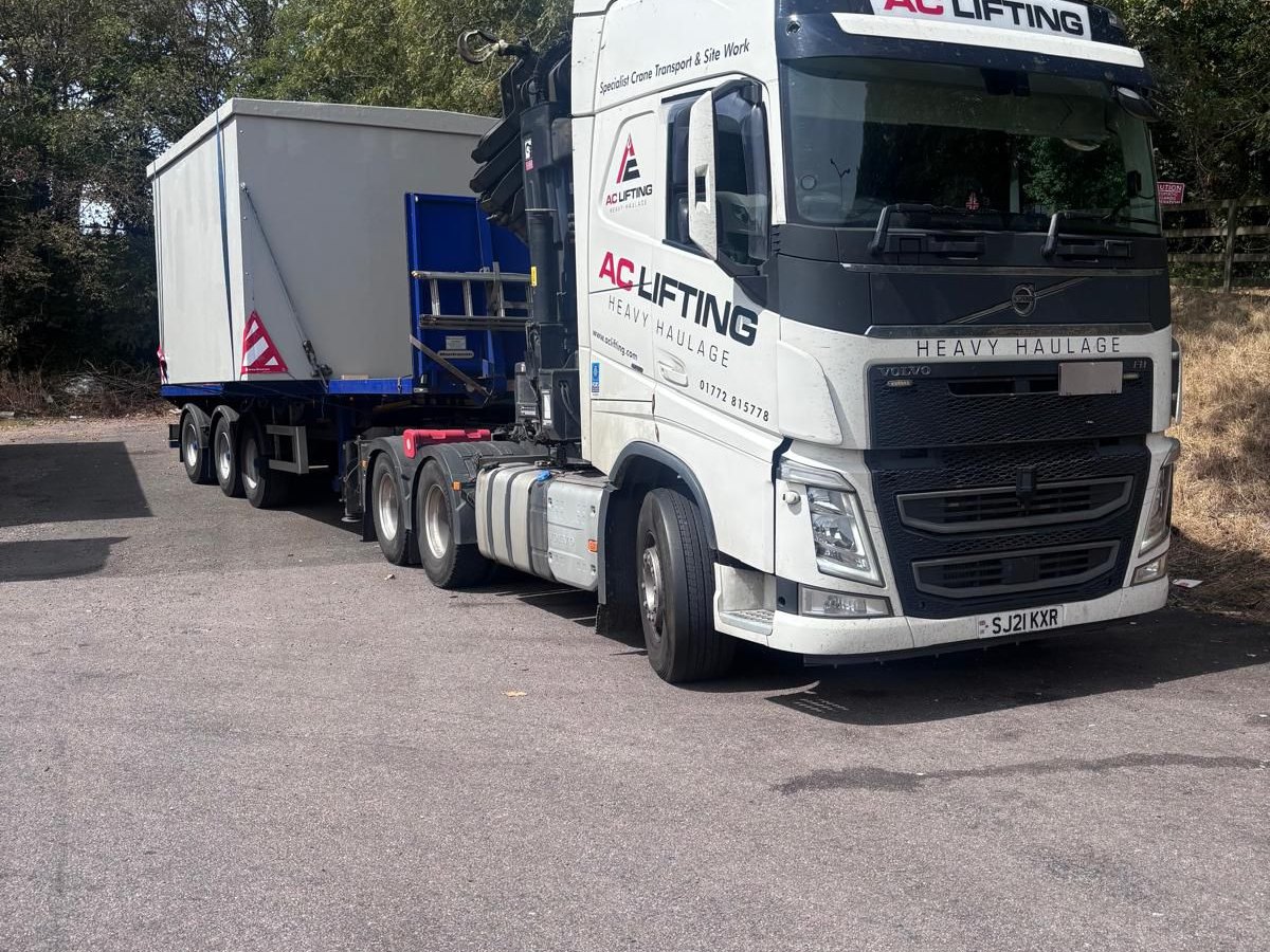 AC Lifting low-loader transporting a large fabricated hopper section.