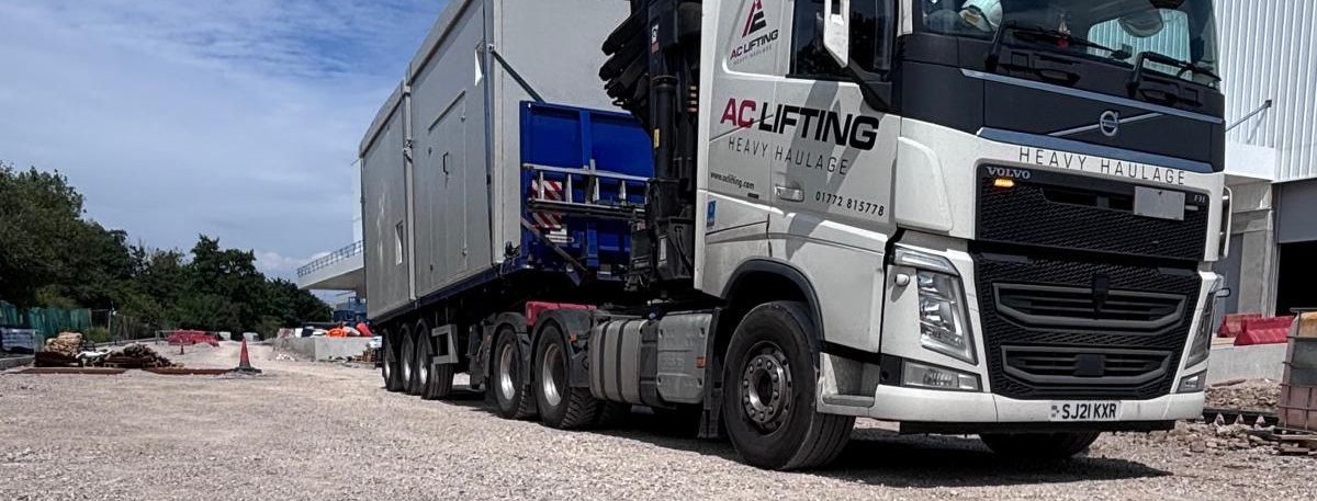 AC Lifting lorry and trailer transporting a large modular plant unit.