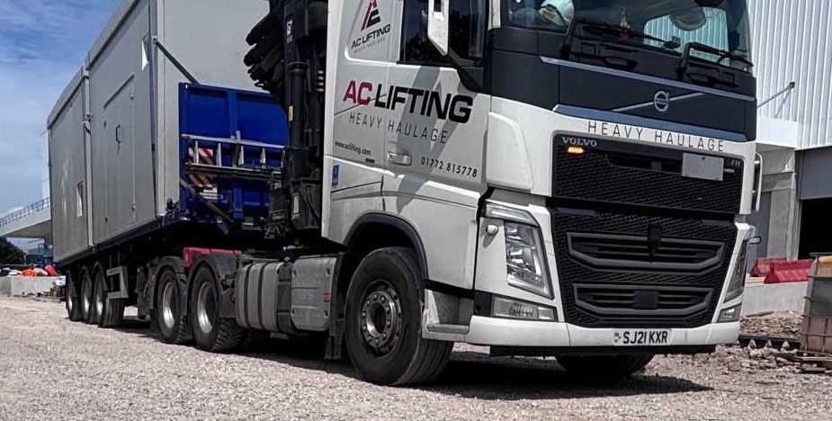 AC Lifting lorry and trailer transporting a large modular plant unit.
