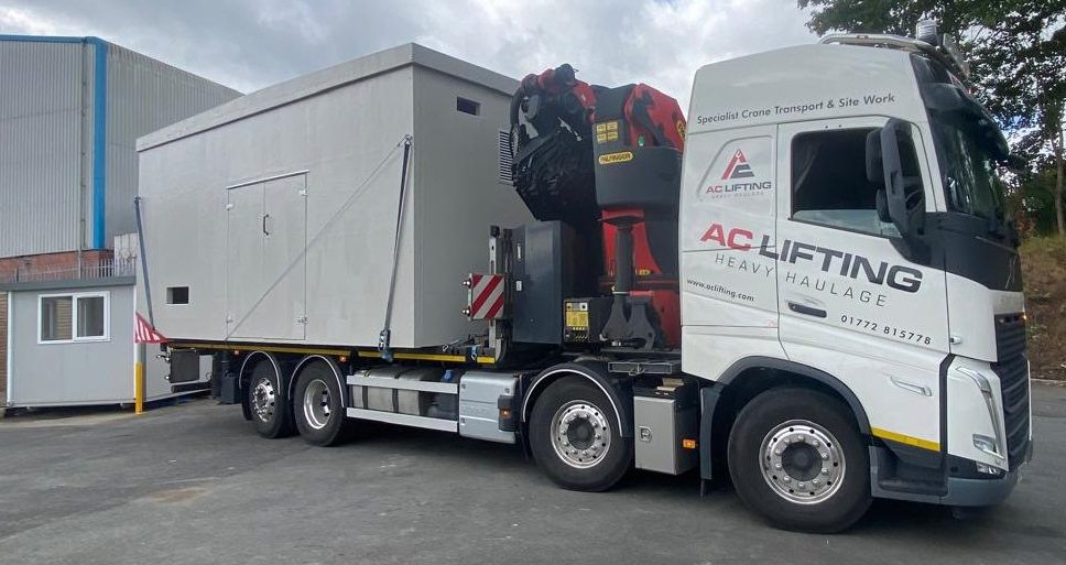 AC Lifting HIAB transporting a modular welfare cabin from the manufacturer.