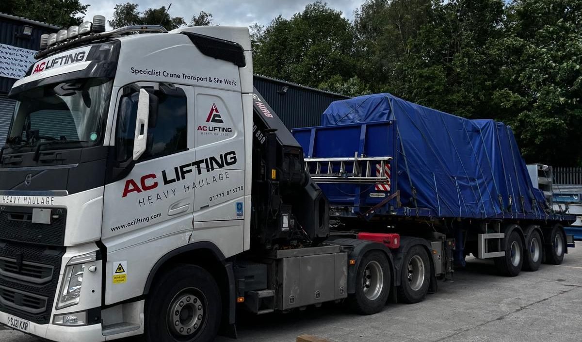 AC Lifting lorry and trailer carrying a sheeted load.