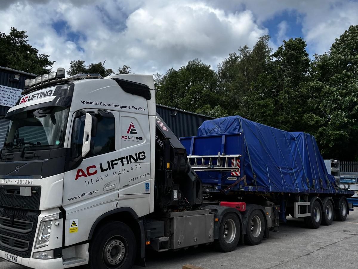 AC Lifting lorry and trailer carrying a sheeted load.