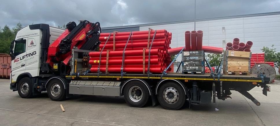 AC Lifting HIAB loaded with steel frames outside an industrial unit.